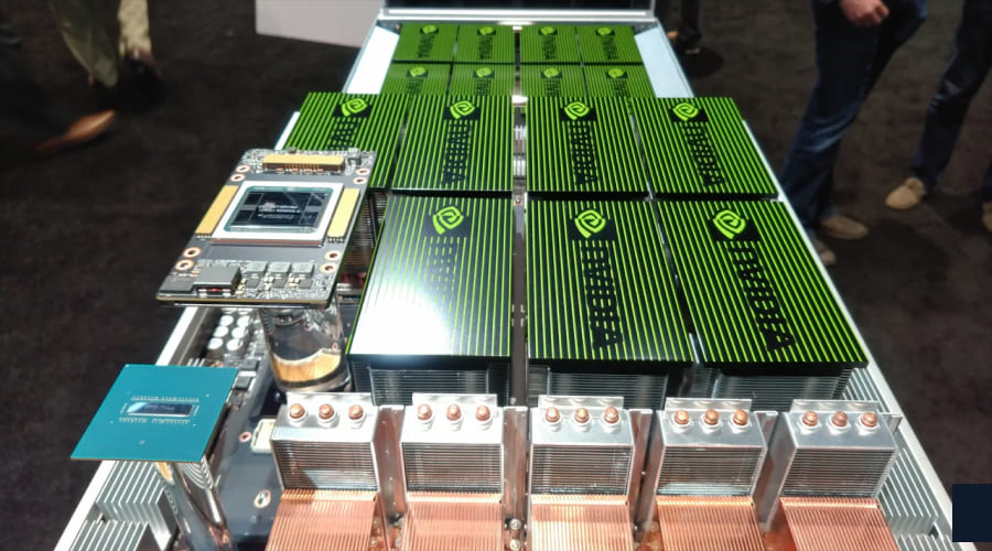 close-up view of an open server chassis featuring multiple NVIDIA GPUs with green-striped heatsinks and copper heat pipes.