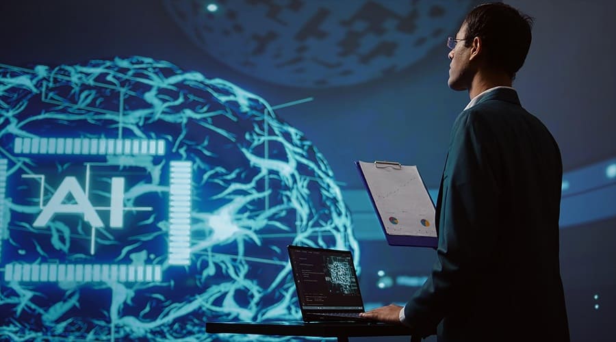 A professional man holding a clipboard stands before a massive holographic projection of a glowing neural network and the letters "AI" in a dark laboratory.