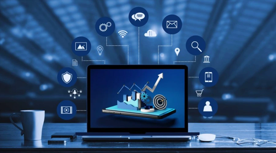 A laptop on a desk displaying a growth chart, surrounded by a semi-circle of digital marketing icons like social media, email, and analytics.