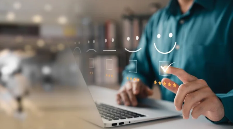 A person clicking a high-satisfaction smiley face icon on a digital feedback interface with a five-star rating below.