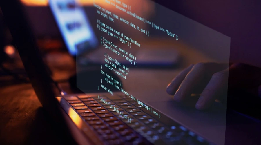 Faster Development - WeeTech Solution Pvt Ltd An angled view of hands typing on a laptop with lines of code overlaid.