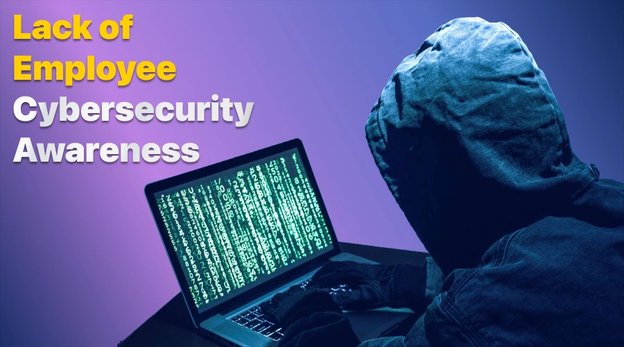 Lack of Employee Cybersecurity Awareness - WeeTech Solution Pvt Ltd A hooded individual in a dark setting viewing a laptop screen filled with lines of cascading green code.
