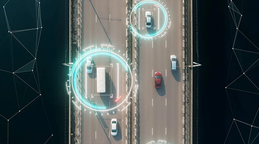 Real-Time Vehicle Tracking - WeeTech Solution Pvt Ltd A top-down aerial view of traffic on a multi-lane bridge with glowing digital tracking circles highlighted around vehicles.