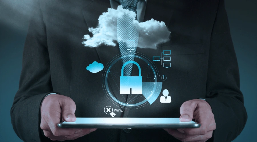 A person in a suit holding a tablet with a glowing, holographic display of a padlock and cloud security symbols.