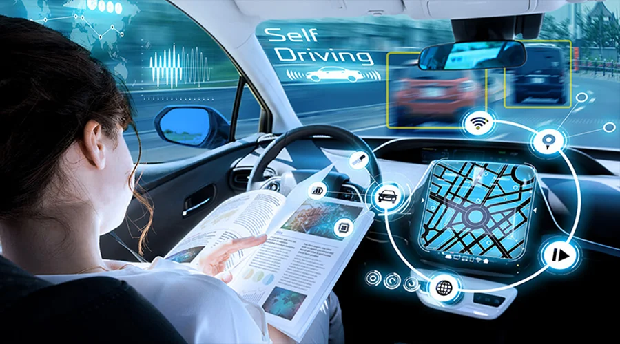 A person reading a book inside a self-driving car with digital dashboard displays.
