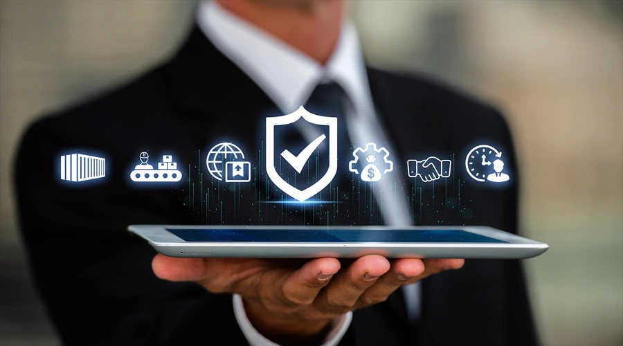 How the nine tools differ - WeeTech Solution Pvt Ltd A person in a business suit holding a tablet with a row of diverse supply chain, security shield, and logistics icons floating above it.