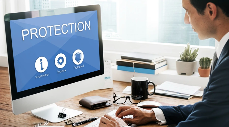 StepSecurity - best for active CICD attack prevention - WeeTech Solution Pvt Ltd A developer typing at a workstation where the computer monitor shows a prominent red and turquoise "ACCESS DENIED" warning over blocks of code.